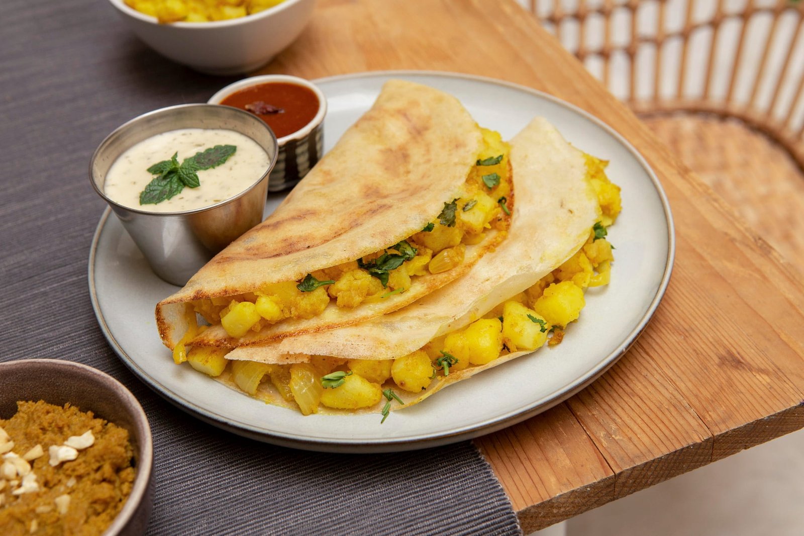 Crispy golden dosa on a plate with coconut chutney and sambar