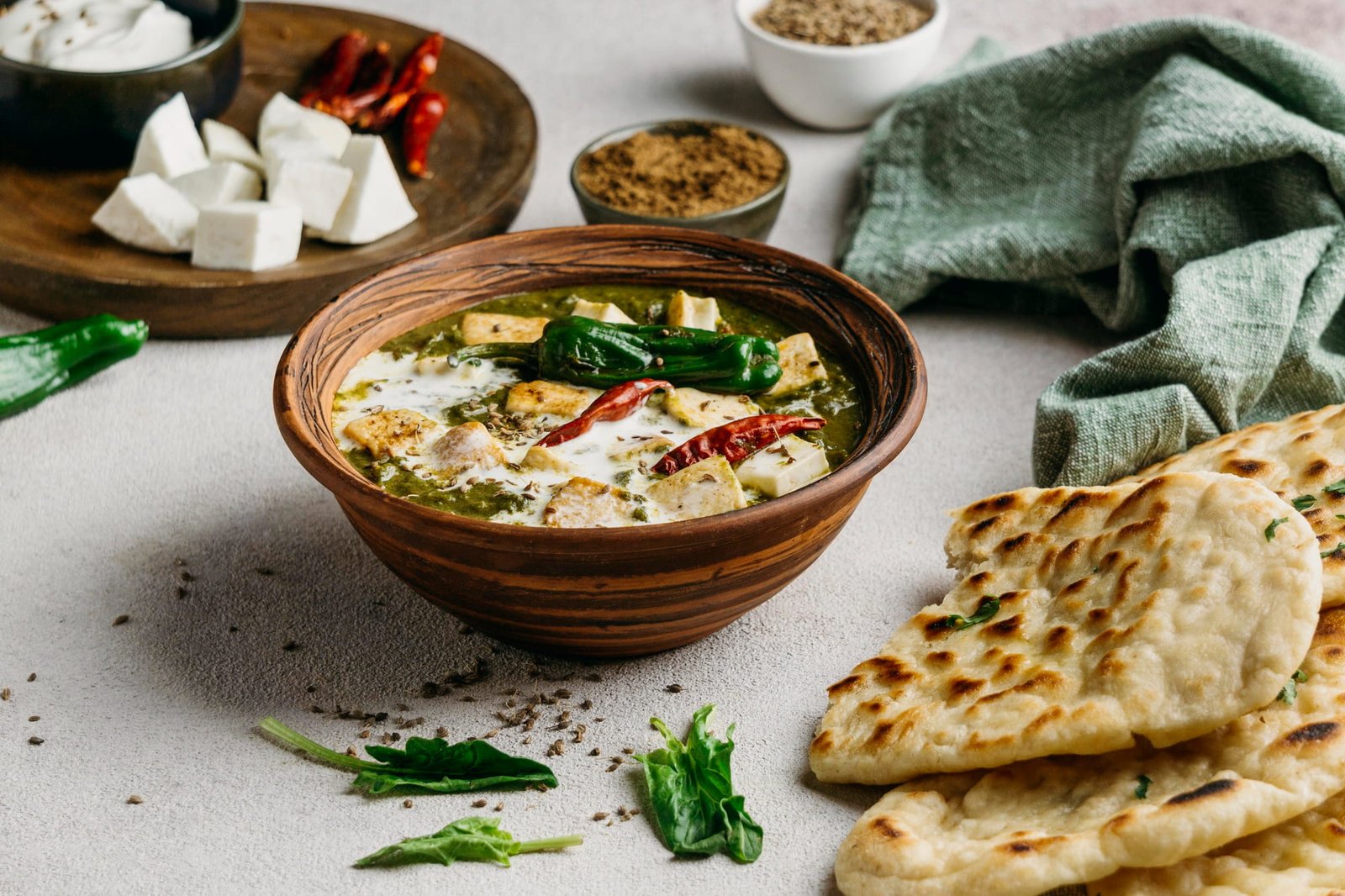 Rich, creamy butter chicken in a bowl with naan