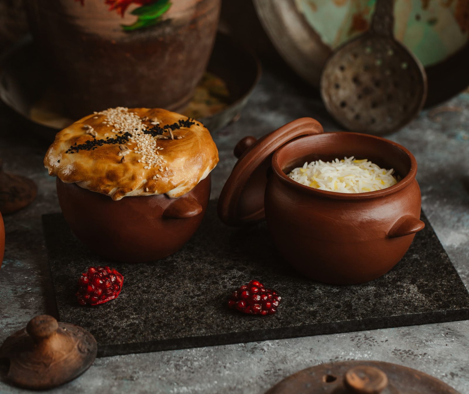 Slow-cooked food in a clay pot with steam rising