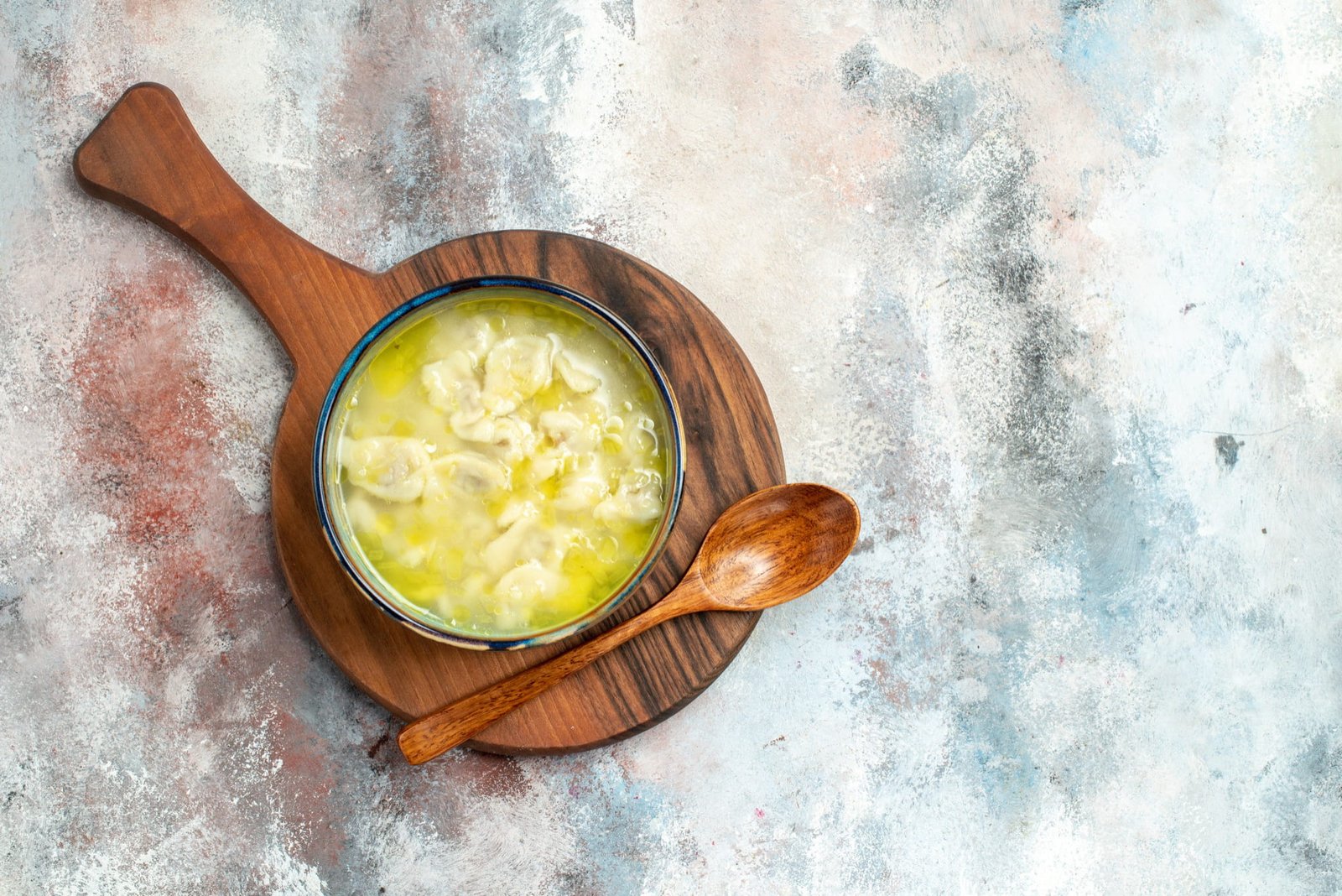 Homemade golden ghee in a jar with a spoon